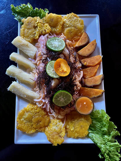 A plate of ceviche in Puerto Maldonado, which also has potatoes, yucca, and plantain bread