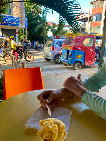 Ice cream with tuk tuks and motorcycles in the background